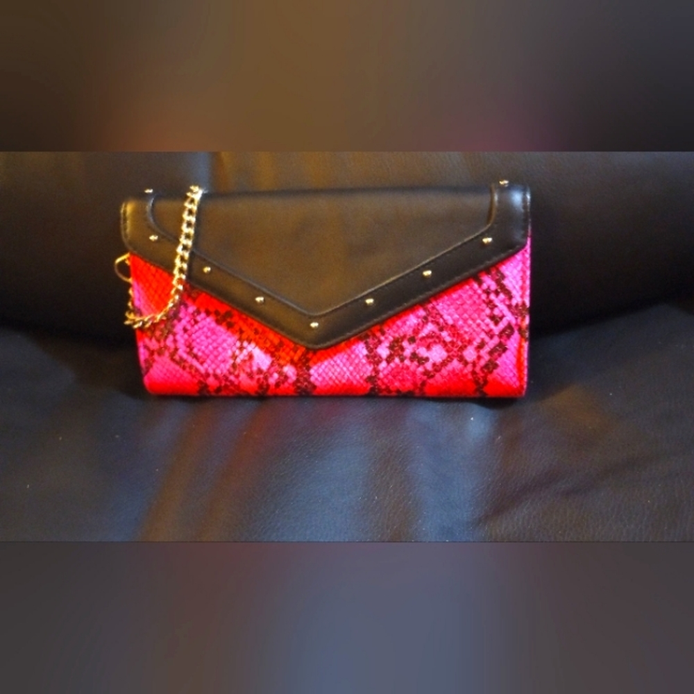 Women's pink and black snake print clutch